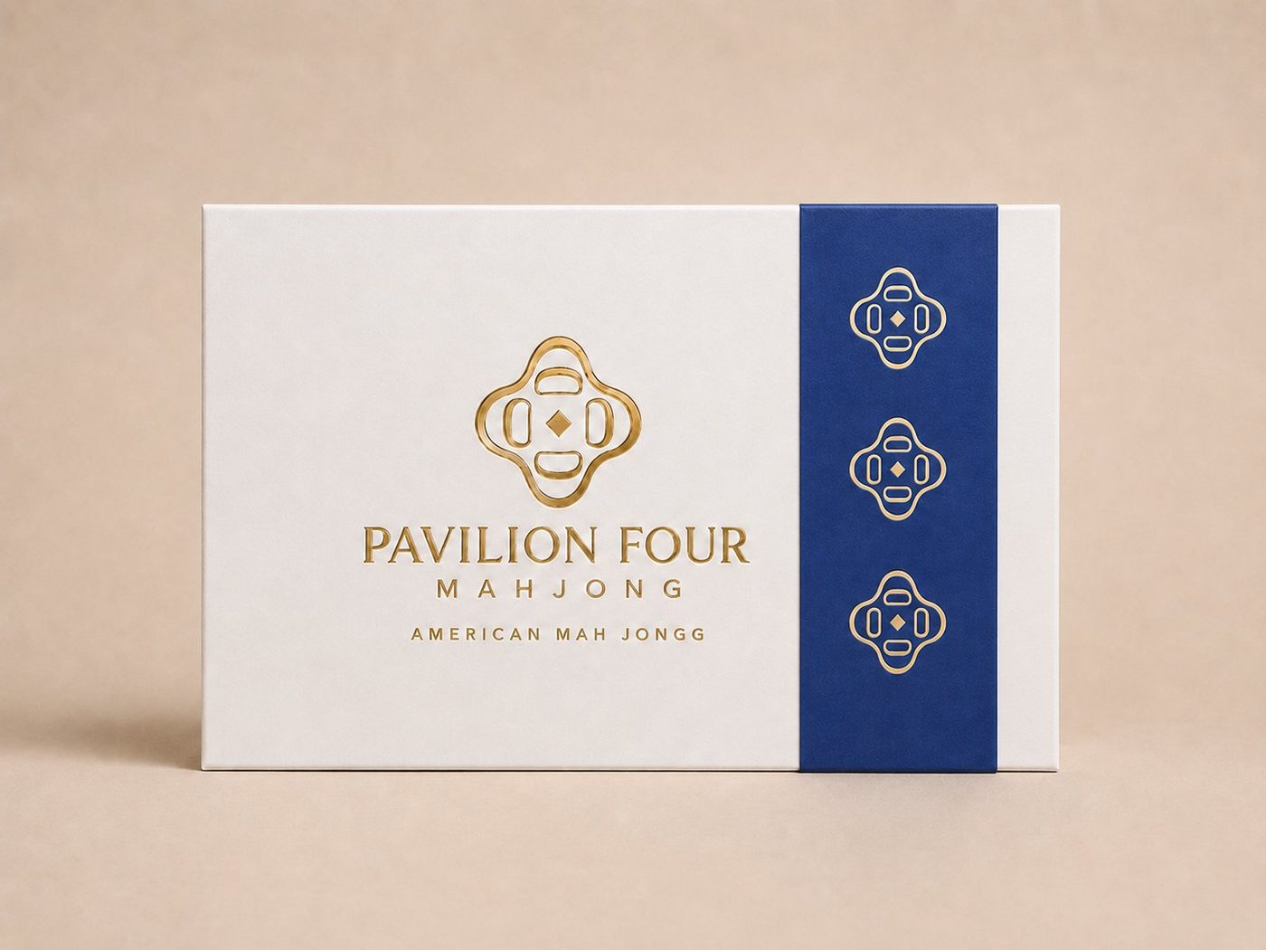 Pavilion Four box with cobalt belly band and gold foil logo